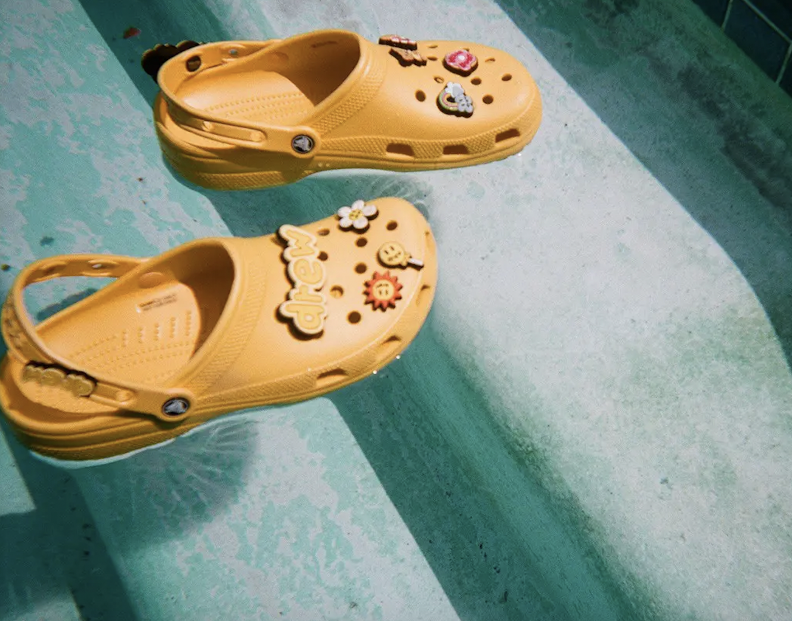 Crocs ad featuring yellow Crocs floating in a pool