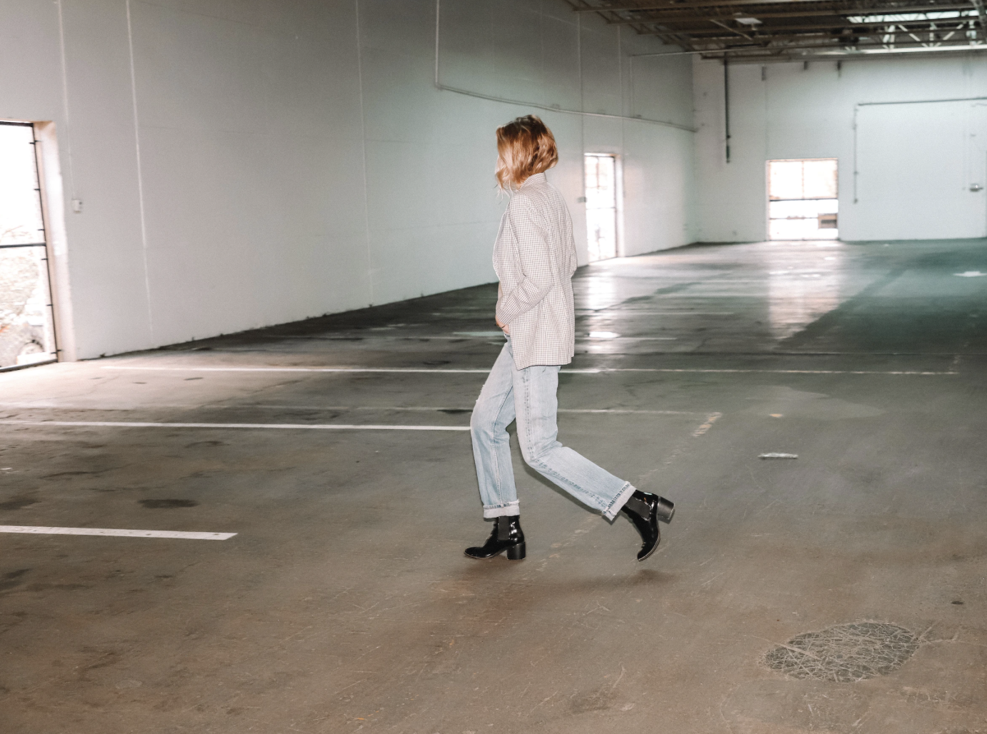 A model walking in a parking garage